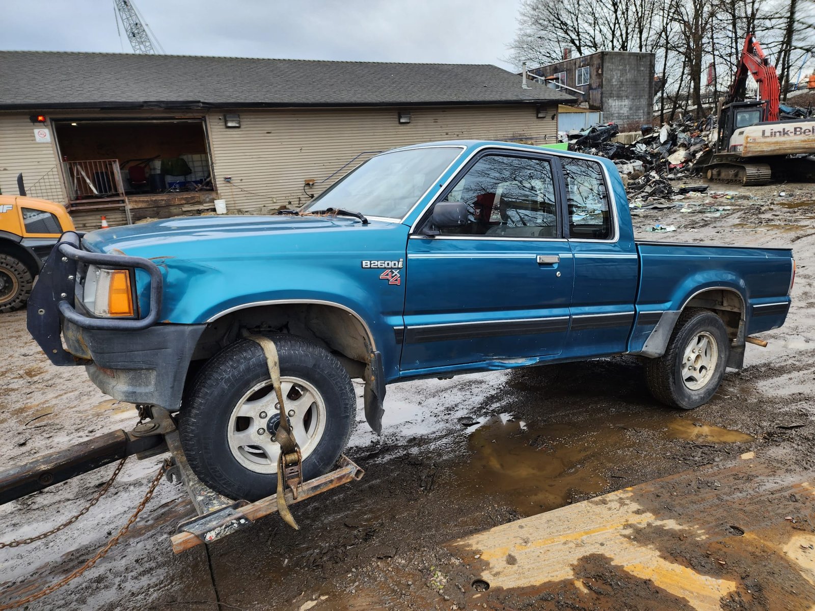 Scrap vehicle loaded onto a flatbed near Snug Cove, Bowen Island